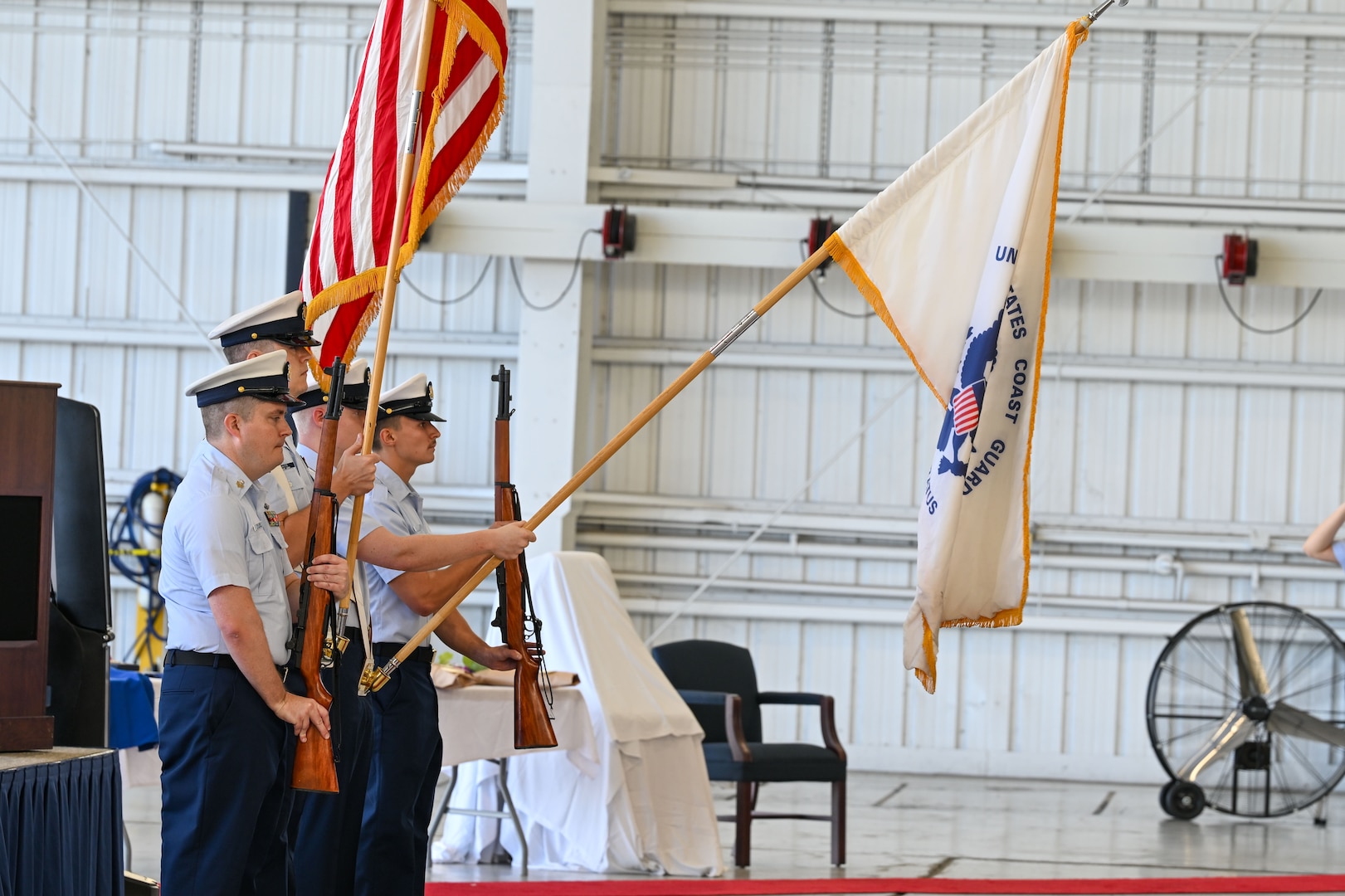 The U.S. Coast Guard Air Station Clearwater color guard presents the colors during a change of command ceremony in Clearwater, Florida, July 24, 2025. The change of command ceremony marks the transfer of total responsibility and authority from one individual to another. It is a time-honored tradition conducted before the assembled crew, as well as honored guests and dignitaries, to formally demonstrate the continuity of authority within a command.  (U.S. Coast Guard photo by Petty Officer 1st Class Riley Perkofski)