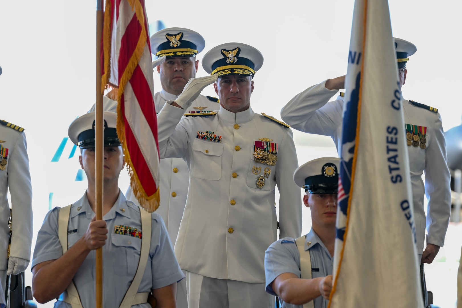 Rear Adm. Adam Chamie, commander of Coast Guard Southeast District, salutes the flag during a change of command ceremony in Clearwater, Florida, July 24, 2025. Air Station Clearwater is composed of more than 400 active duty, reserve, Auxiliary and civilian personnel, who provide critical mission support to the Southeast District.  (U.S. Coast Guard photo by Petty Officer 1st Class Riley Perkofski)
