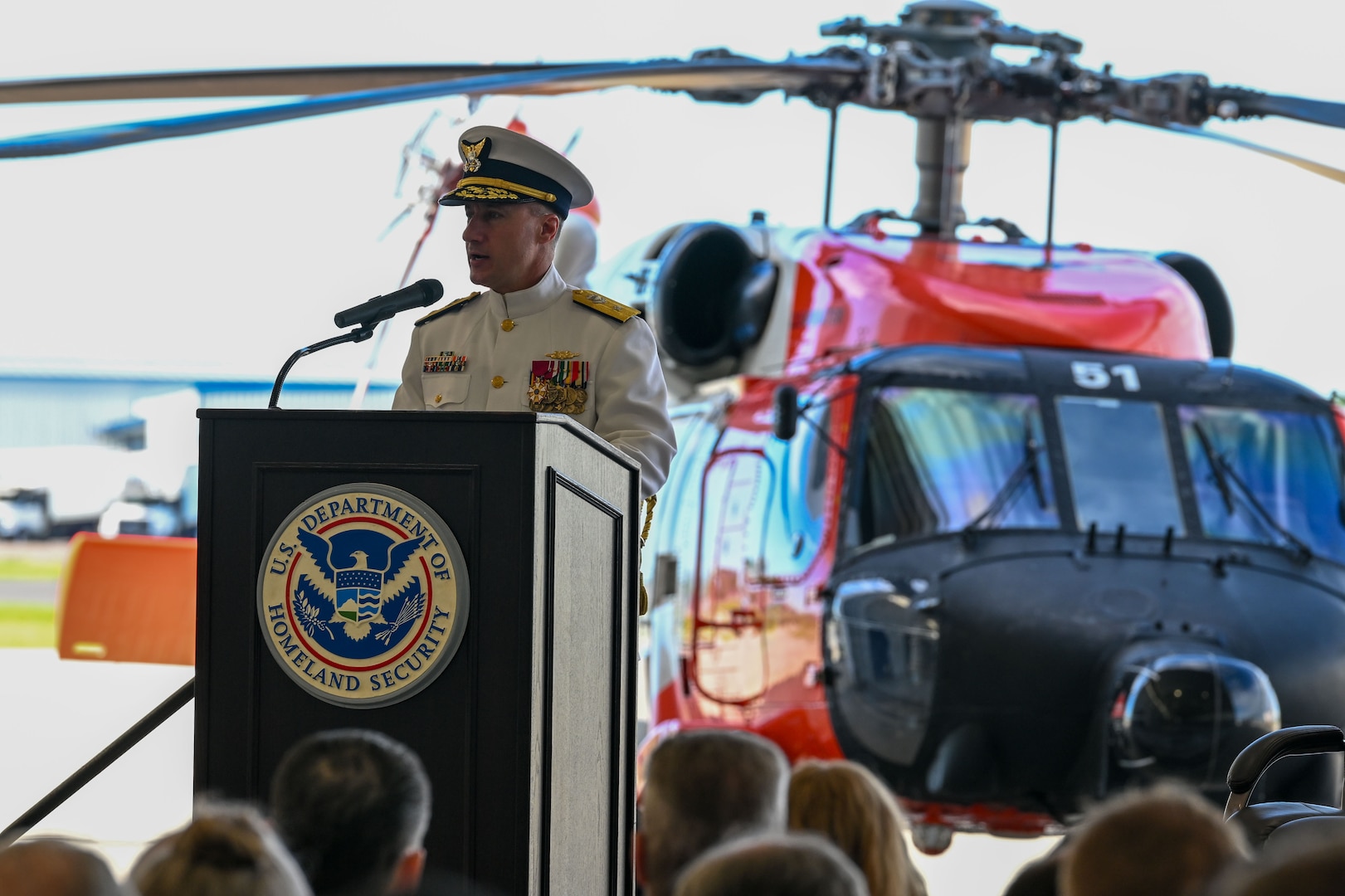 Rear Adm. Adam Chamie, commander of Coast Guard Southeast District, addresses members of U.S. Coast Guard Air Station Clearwater during a change of command ceremony in Clearwater, Florida, July 24, 2025. Air Station Clearwater is composed of more than 400 active duty, reserve, Auxiliary and civilian personnel, who provide critical mission support to the Southeast District.  (U.S. Coast Guard photo by Petty Officer 1st Class Riley Perkofski)