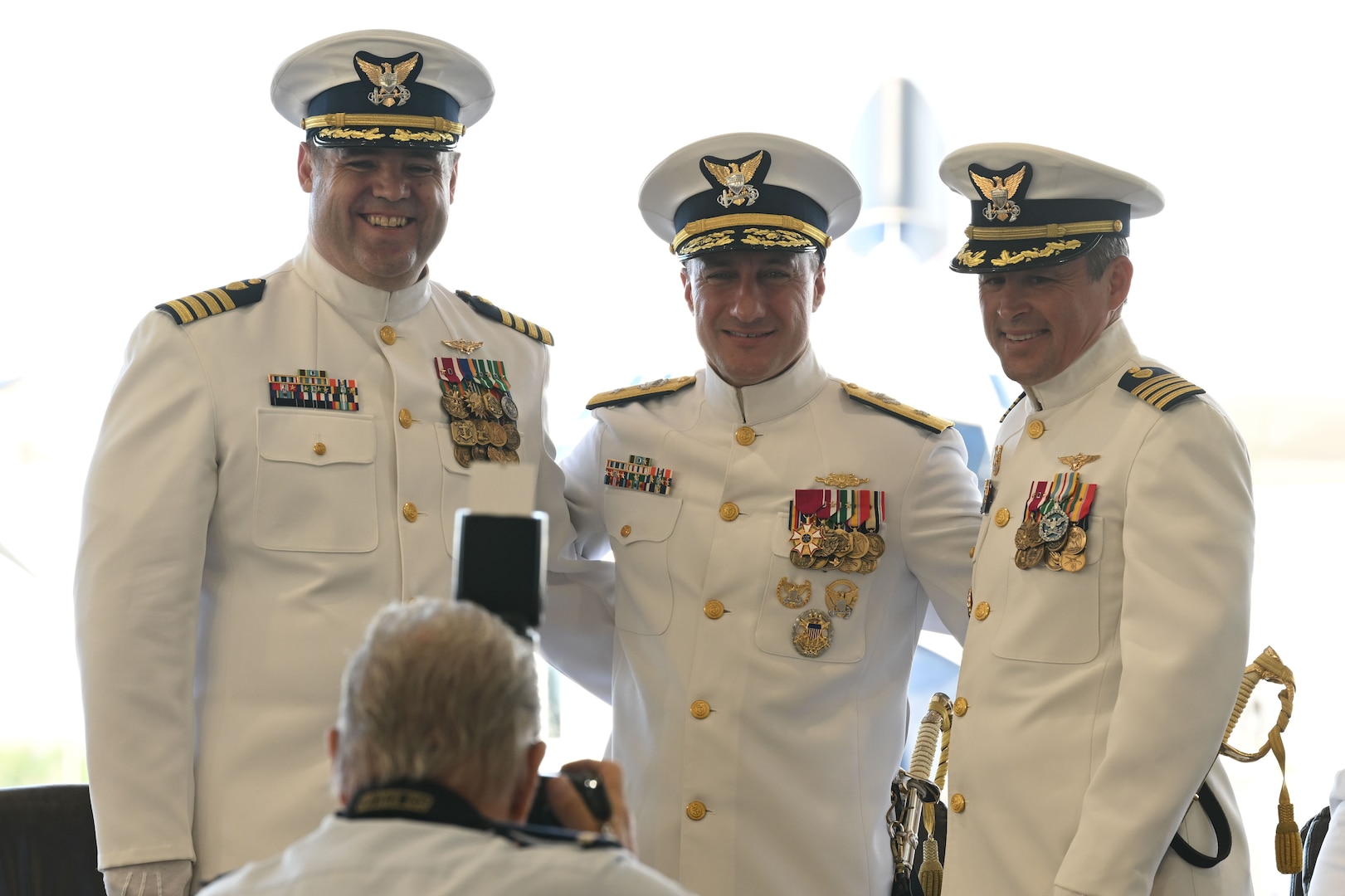 Pictured left to right, Capt. David McCown (left), Rear Adm. Adam Chamie (middle) and Capt. Scott Phy (right), pose for a photo during a change of command ceremony in Clearwater, Florida, July 24, 2025. Capt. David McCown relieved Capt. Scott Phy as commanding officer of Coast Guard Air Station Clearwater during the change of command ceremony. (U.S. Coast Guard photo by Petty Officer 1st Class Riley Perkofski)