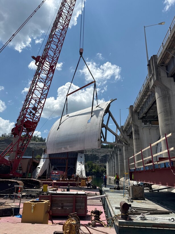 Work crews successfully remove the first massive spillway gate from Wolf Creek Dam July 23, 2025, on the Cumberland River in Jamestown, Kentucky. The U.S. Army Corps of Engineers Nashville District and its contractor, American Bridge Company, hoisted the 37-feet high by 50-feet wide gate and placed it on a work barge on Lake Cumberland. This action signals the modernization of the dam's infrastructure, replacing all 10 original tainter gates and lifting equipment that have been in continuous operation since 1952. (USACE Photo by Joshua Gantt)