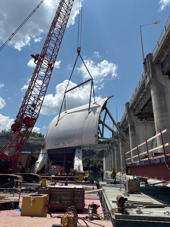 Work crews successfully remove the first massive spillway gate from Wolf Creek Dam July 23, 2025, on the Cumberland River in Jamestown, Kentucky. The U.S. Army Corps of Engineers Nashville District and its contractor, American Bridge Company, hoisted the 37-feet high by 50-feet wide gate and placed it on a work barge on Lake Cumberland. This action signals the modernization of the dam's infrastructure, replacing all 10 original tainter gates and lifting equipment that have been in continuous operation since 1952. (USACE Photo by Joshua Gantt)