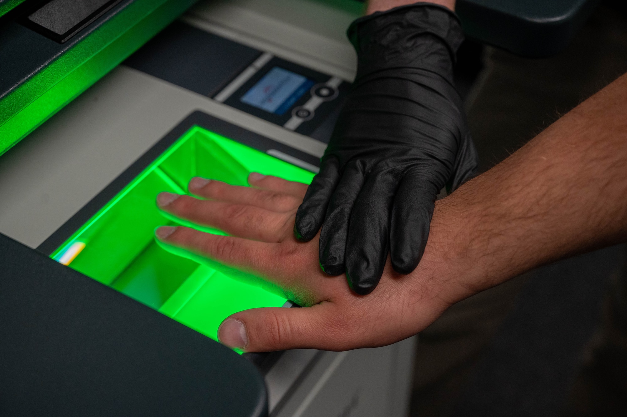 Special Agent Isaiah Moore, assigned to Air Force Office of Special Investigations (AFOSI) Detachment 422, scans a subject’s fingerprints into the Live Scan Management System (LSMS) at Altus Air Force Base, Oklahoma, July 22, 2025. AFOSI Special Agents LSMS to criminally book subjects of investigations. (U.S. Air Force photo by Senior Airman Kari Degraffenreed)