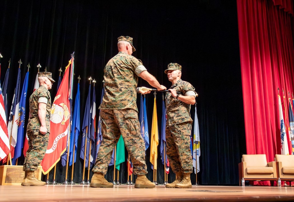 Relief & Appointment (8 Jul 2025). Education Command / Marine Corps University bids farewell to SgtMaj Stephen J. Lutz Jr. as he relinquishes his billet to SgtMaj George Garcia III, former director of the Staff Non-Commissioned Officer Academy Camp Pendleton. BGen Matthew Tracy, Commanding General of EDCOM/President of MCU, receives the sword of office from Lutz and passes it to Garcia, signifying the transfer of responsibility and authority. (Photo by Mr. Thanh Truong)
