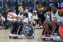 U.S. Army Cpt. Carlos Rivera, left, catches the ball next to Master Sgt. Earlie Brown in a wheelchair rugby match during the 2025 Department of Defense Warrior Games at Ed Robson Arena, Colorado Springs, Colorado, July 22, 2025.