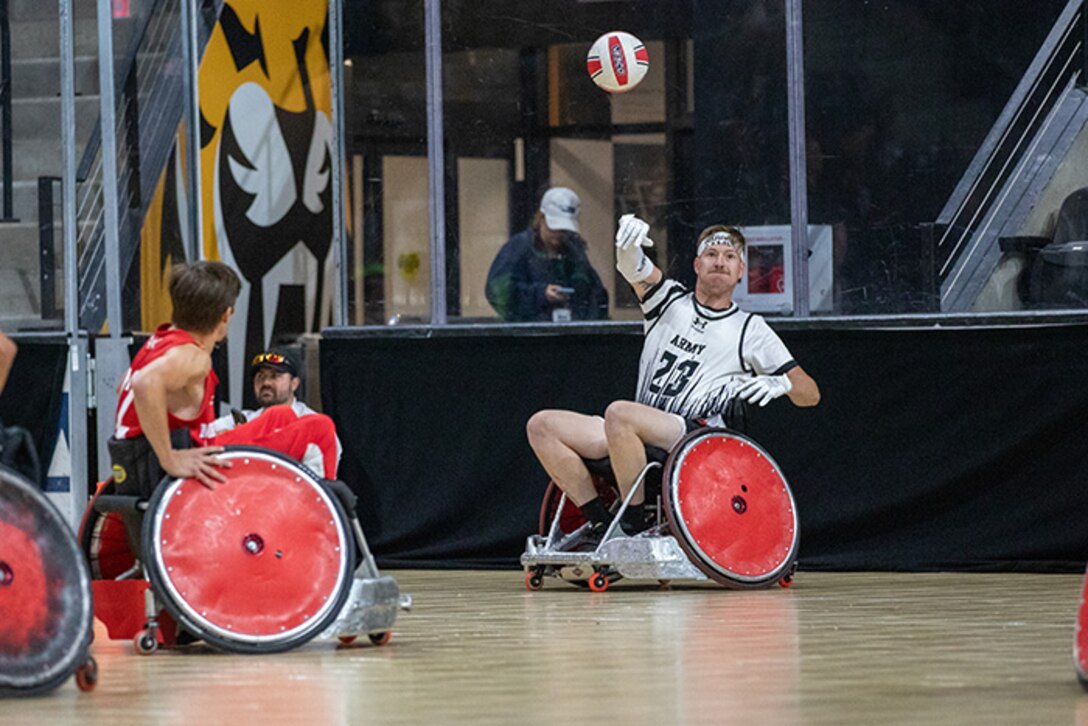 U.S. Army Staff Sgt. Coty Tuck passes the ball down court in a wheelchair rugby match during the 2025 Department of Defense Warrior Games at Ed Robson Arena, Colorado Springs, Colorado, July 22, 2025.