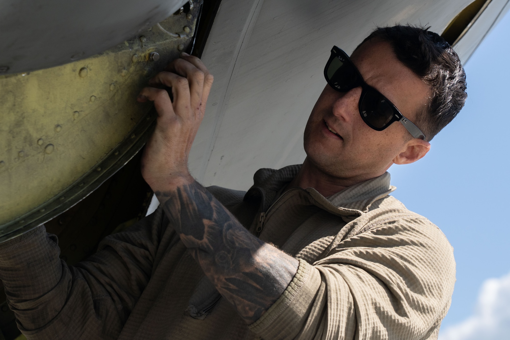 Airmen perform maintenance on an aircraft.