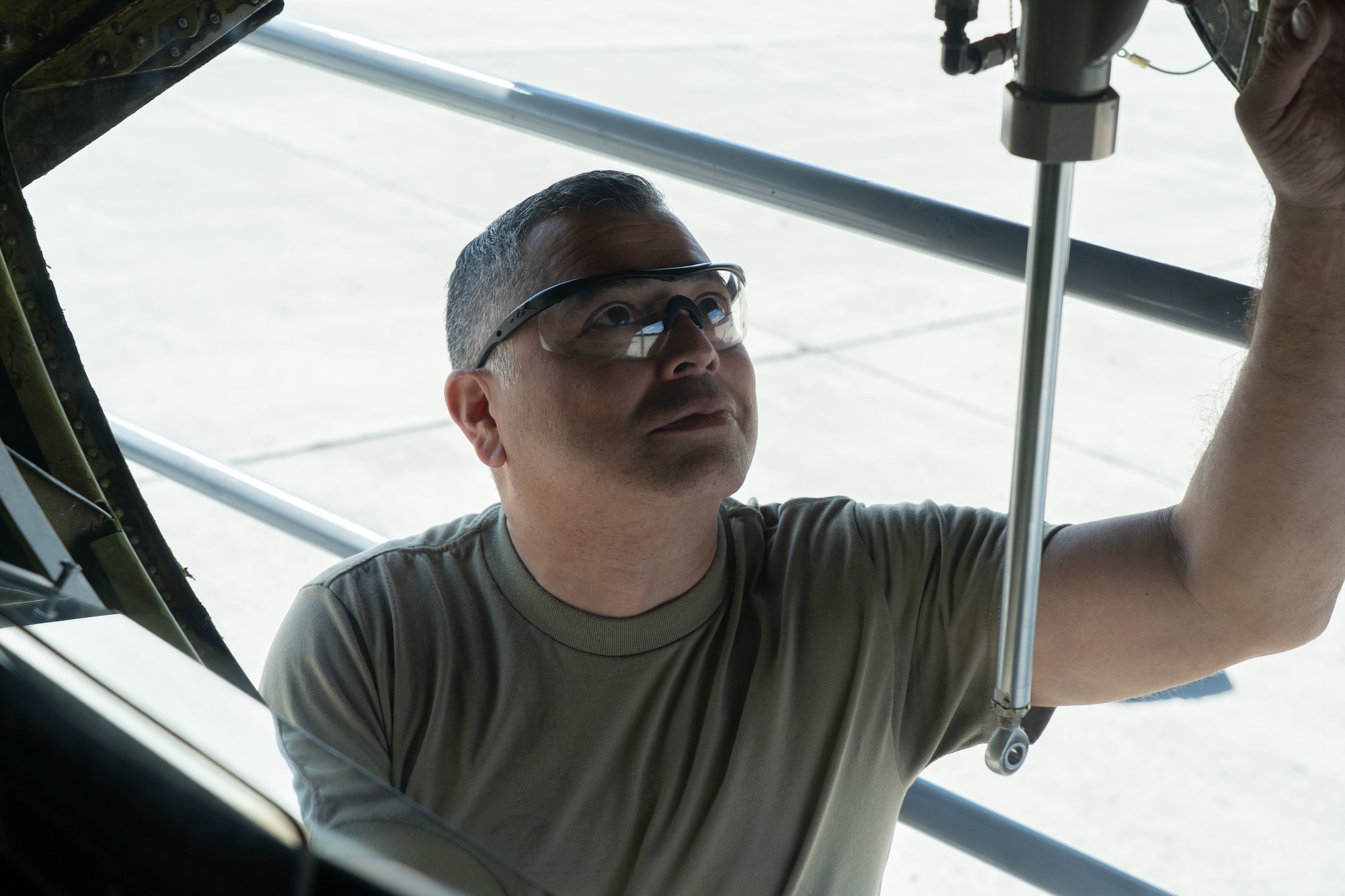 Airmen perform maintenance on an aircraft.