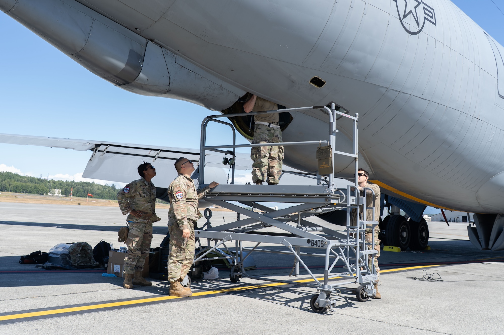 Airmen perform maintenance on an aircraft.