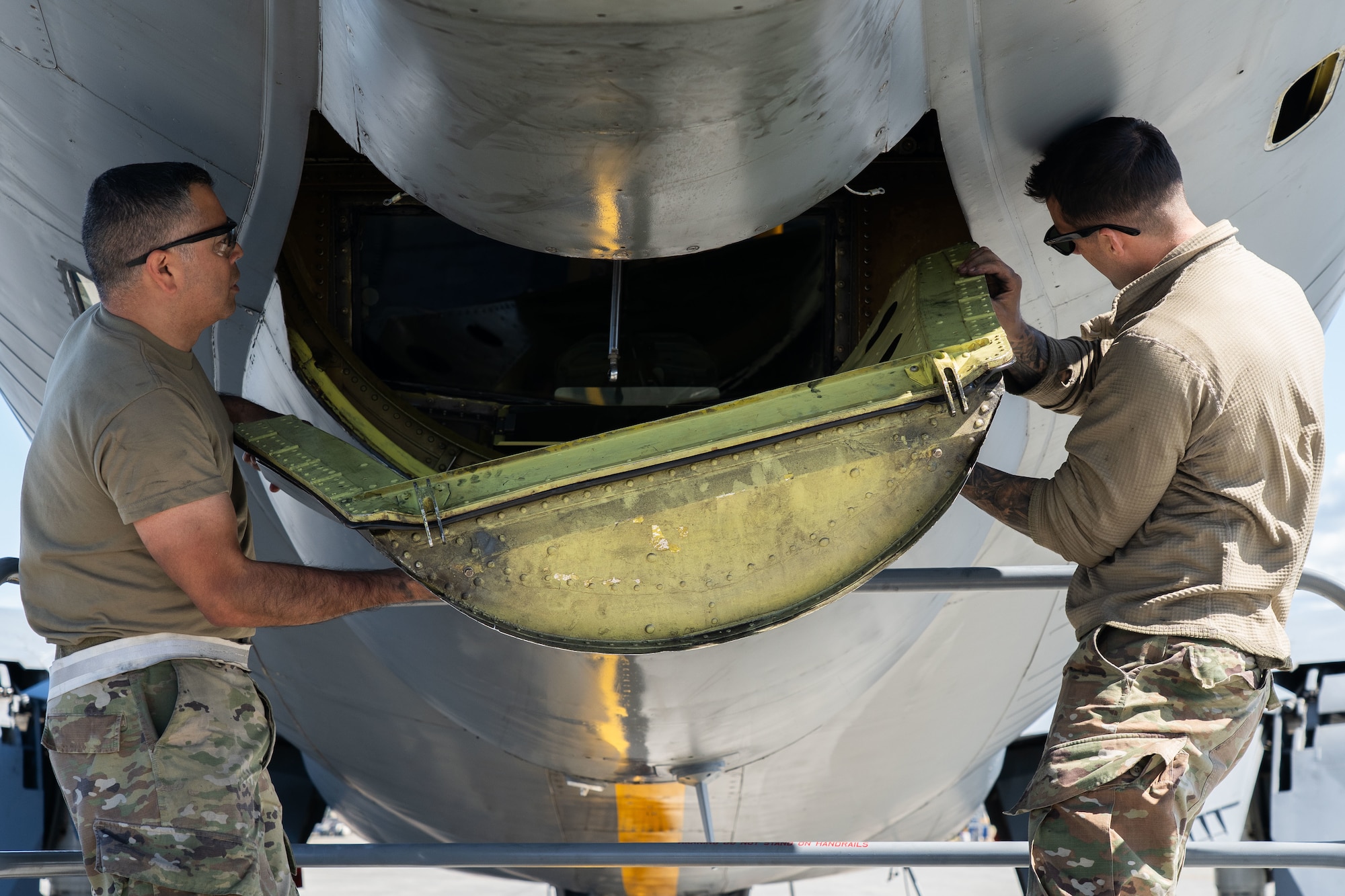 Airmen perform maintenance on an aircraft.