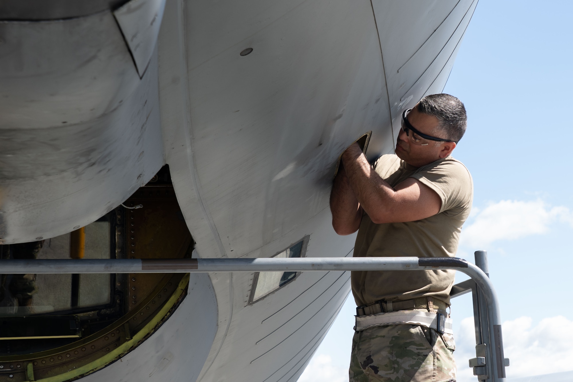 Airmen perform maintenance on an aircraft.