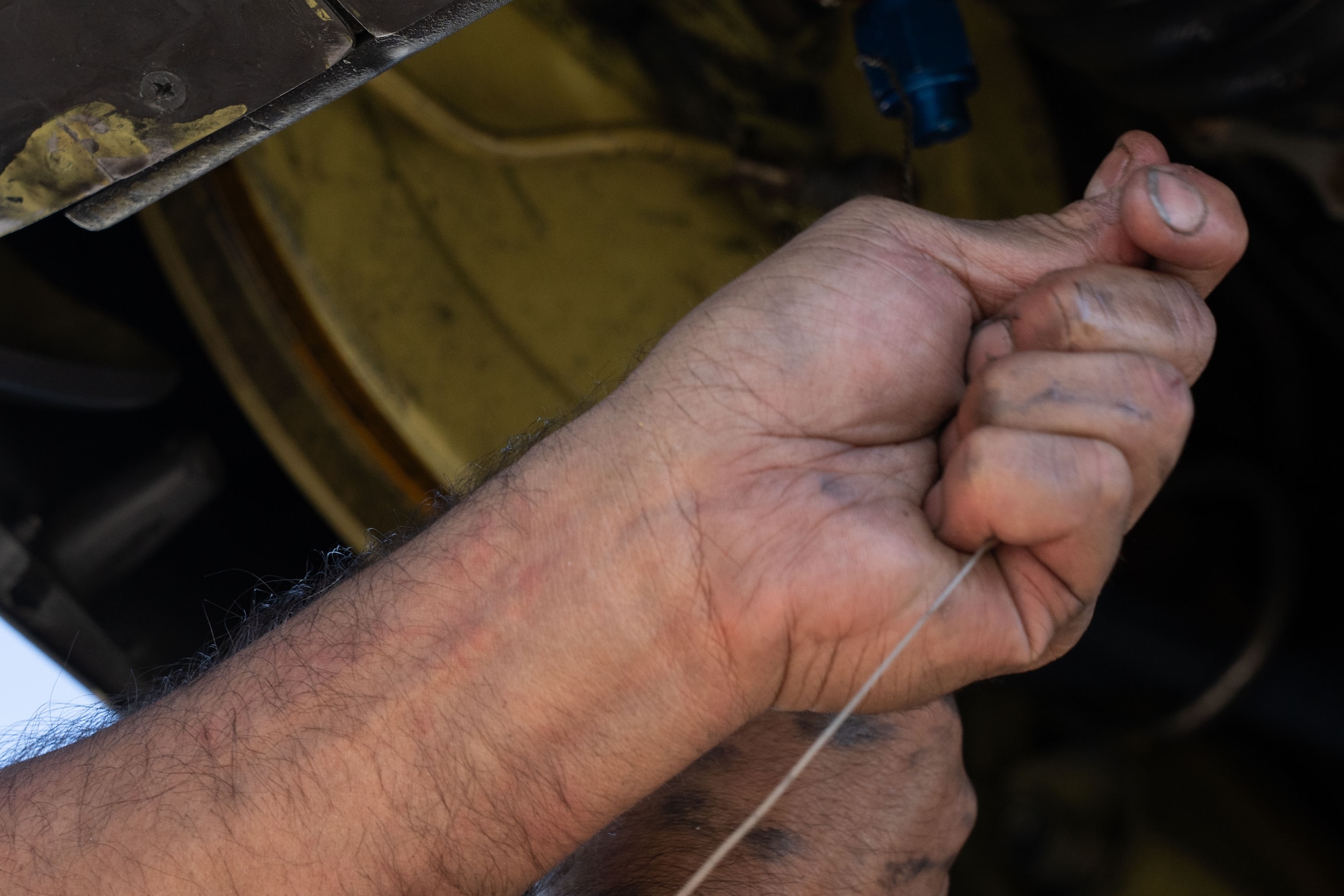 Airmen perform maintenance on an aircraft.