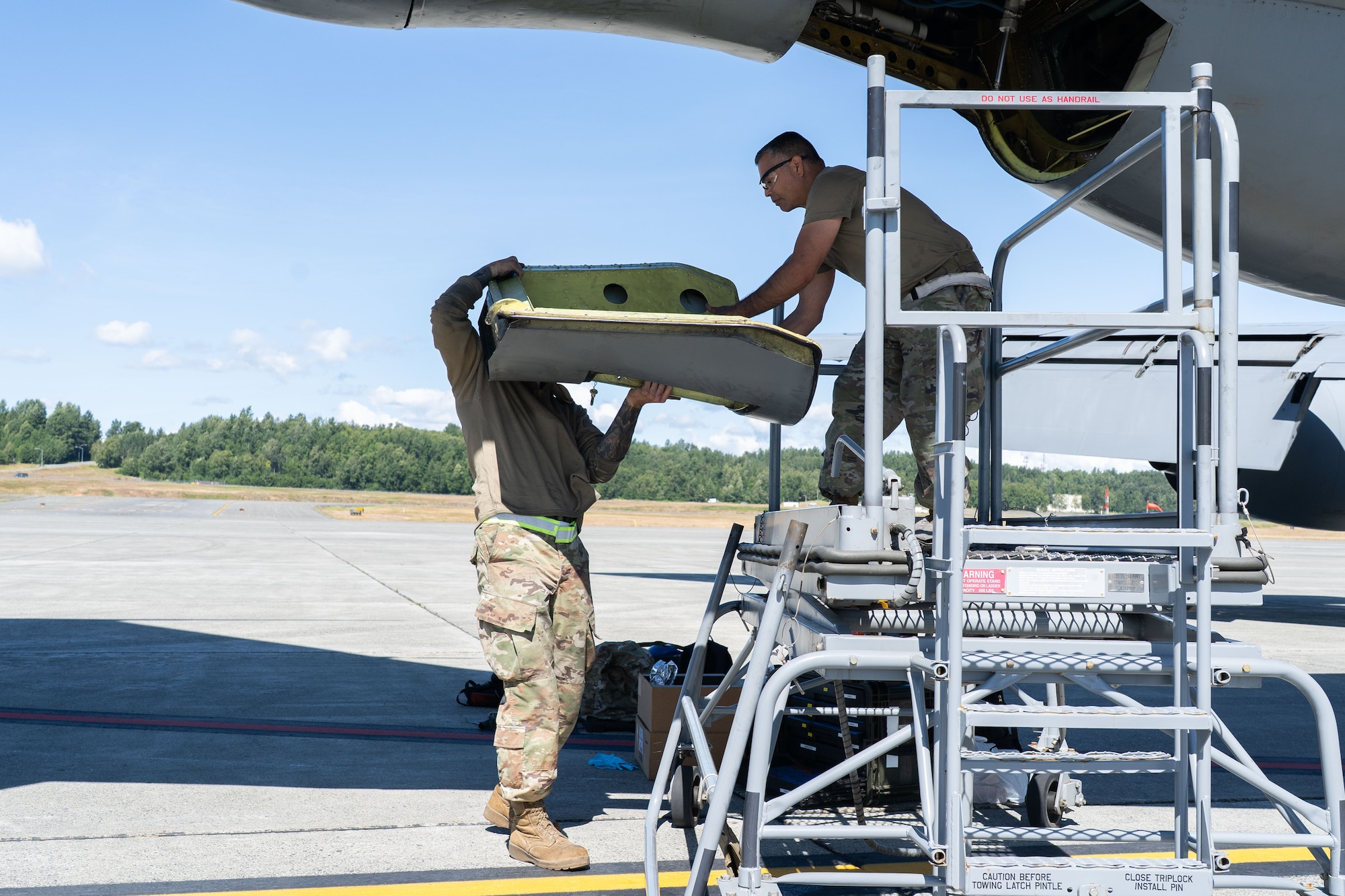 Airmen perform maintenance on an aircraft.