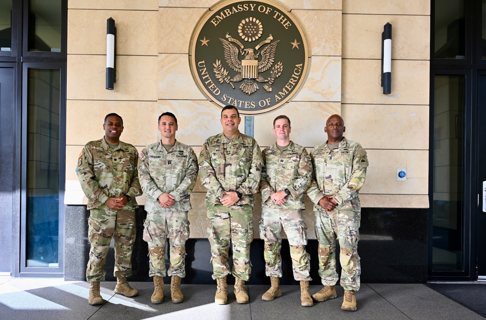 U.S. Army Lt. Col. Angel Lopez Jr., senior defense official/defense attaché; U.S. Army Capt. Chad Pickering, incoming Bilateral Affairs Officer; U.S. Army Maj. Gen. John C. Andonie, Commanding General (Interim) of the D.C. National Guard; U.S. Army Capt. Aaron Lies, outgoing Bilateral Affairs Officer, and U.S. Army Command Sgt. Maj. Ronald L. Smith Jr., Command Senior Enlisted Leader (CSEL) for the DCNG, stand outside the U.S. Embassy in Kingston, Jamaica, on July 18, 2025. Maj. Gen. Andonie and CSM Smith visited Jamaica to discuss ongoing partnerships between the D.C. National Guard and the Jamaica Defense Force.