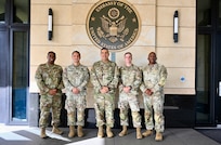 U.S. Army Lt. Col. Angel Lopez Jr., senior defense official/defense attaché; U.S. Army Capt. Chad Pickering, incoming Bilateral Affairs Officer; U.S. Army Maj. Gen. John C. Andonie, Commanding General (Interim) of the D.C. National Guard; U.S. Army Capt. Aaron Lies, outgoing Bilateral Affairs Officer, and U.S. Army Command Sgt. Maj. Ronald L. Smith Jr., Command Senior Enlisted Leader (CSEL) for the DCNG, stand outside the U.S. Embassy in Kingston, Jamaica, on July 18, 2025. Maj. Gen. Andonie and CSM Smith visited Jamaica to discuss ongoing partnerships between the D.C. National Guard and the Jamaica Defense Force.