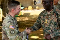 U.S. Army Capt. Aaron Lies, outgoing Bilateral Affairs Officer, greets Brig. Ricardo Blidgen, commander of the Jamaica National Reserve, during the Caribbean Regional Training Camp 2025, in Kingston, Jamaica, on July 18, 2025. Capt. Lies completed a two-year tour in Jamaica serving as a critical liaison facilitating military-to-military engagements and joint training, ensuring the continued strength of a long-standing partnership.