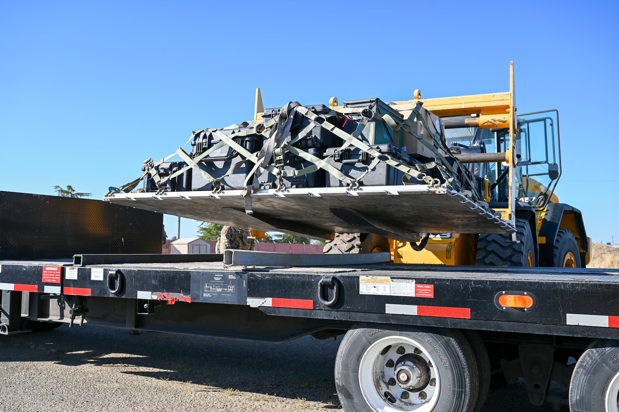 A forklift loads cargo onto a trailer during an Prime Base Engineer Emergency Force (BEEF) exercise on Beale Air Force Base, California, July 17, 2025.