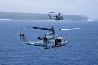 OKINAWA, Japan (July 19, 2025) — A U.S. Marine Corps UH-1Y Venom and an AH-1Z Viper helicopter with Marine Light Attack Helicopter Squadron 169, Marine Aircraft Group 36, 1st Marine Aircraft Wing fly off the coast of Okinawa, Japan, July 19, 2025....