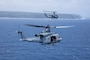 A U.S. Marine Corps UH-1Y Venom and an AH-1Z Viper helicopter with Marine Light Attack Helicopter Squadron 169, Marine Aircraft Group 36, 1st Marine Aircraft Wing fly off the coast of Okinawa, Japan, July 19, 2025.