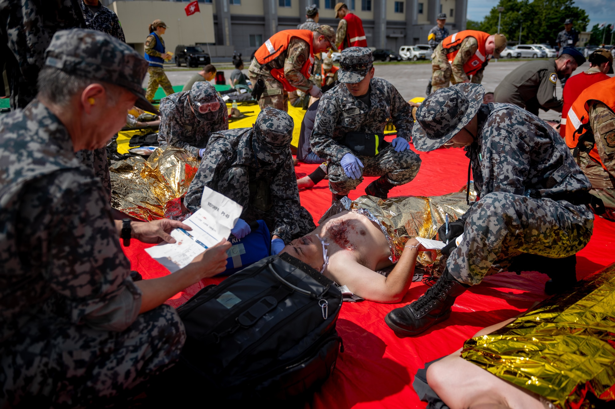 Japan Air Self-Defense Force airmen assigned to the 3rd Air Wing perform simulated medical triage during a bilateral aeromedical evacuation training event as part of exercise Resolute Force Pacific (REFORPAC) 2025.