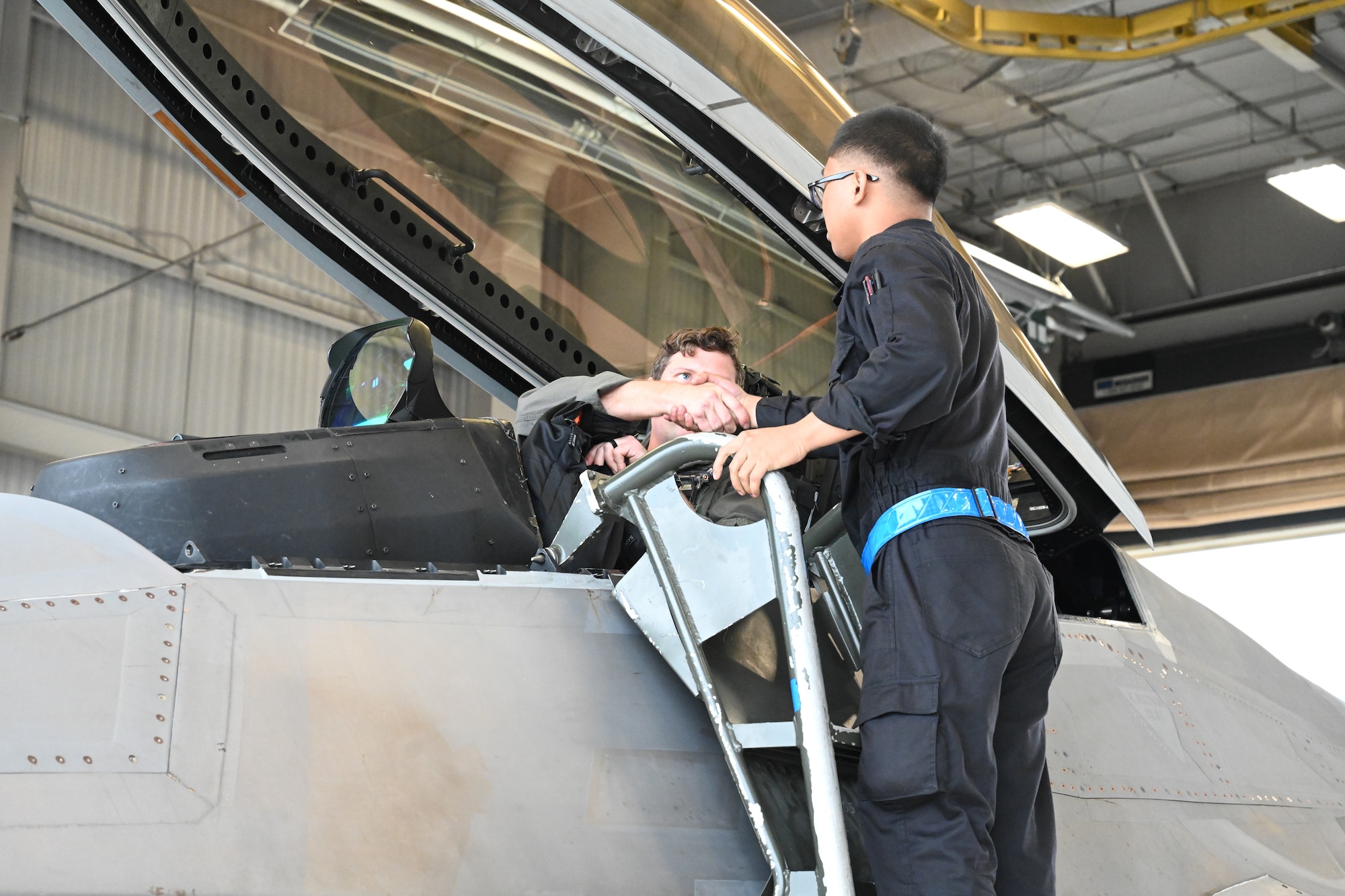 An Airman shakes hands with a pilot.