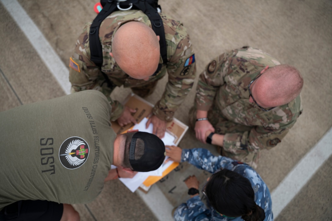 A U.S. Special Operations Forces Operator retrieves a cold chain blood resupply shipment from U.S. Army Sgt. 1st Class Eric Jimenez, medical logistics noncommissioned officer; Royal Australian Air Force Flt. Lt. Pooja Sapkota, scientific officer and pathology advisor, both with the Combined Joint Theatre Medical Component; and a member of the U.S. Air Force’s C-17 Globemaster crew, 535th Airlift Squadron, in Queensland, Australia, during Exercise Talisman Sabre 2025 on July 22, 2025.