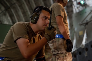 A U.S. Air Force Airman assigned to the 730th Air Mobility Squadron communicates on his radio during exercise Resolute Force Pacific (REFORPAC) 2025 at Misawa Air Base, Japan, July 18, 2025.