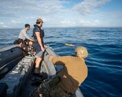 Royal New Zealand Navy Able Hydrographic System Operator Blake Todd, assigned to HMNZS Matataua, and U.S. Navy Robotics Warfare Specialist 2nd Class Roddrick Guerra, assigned to Explosive Ordnance Disposal Mobile Unit 5, launch a Remus 100 autonomous underwater vehicle from a rigid-hull inflatable boat assigned to the Lewis B. Puller-class expeditionary sea base USS John L. Canley (ESB 6) off the coast of Australia during Talisman Sabre, July 18, 2025.
