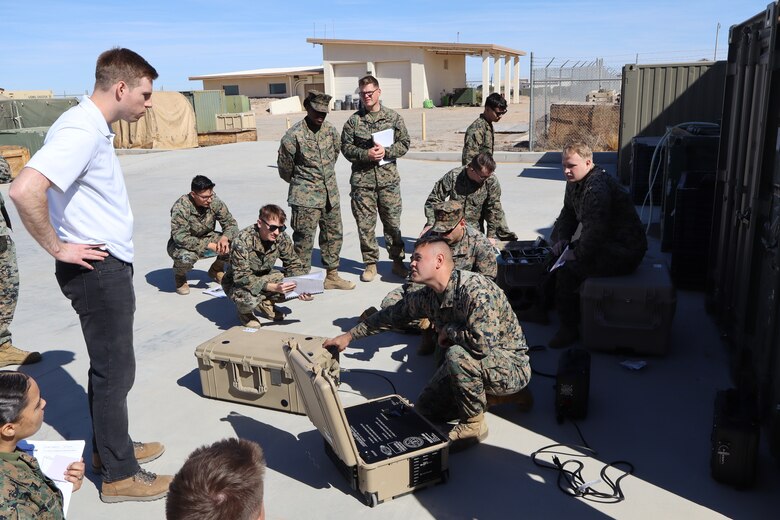 U.S. Naval Research Laboratory Principal Investigator Kevin Cronin (left) trains Marines from Marine Wing Support Squadron 371 on the operation of the Hydrogen Small Unit Power (H-SUP) at Marine Corps Air Station Yuma, Arizona, Feb. 19, 2025. (U.S. Navy photo)