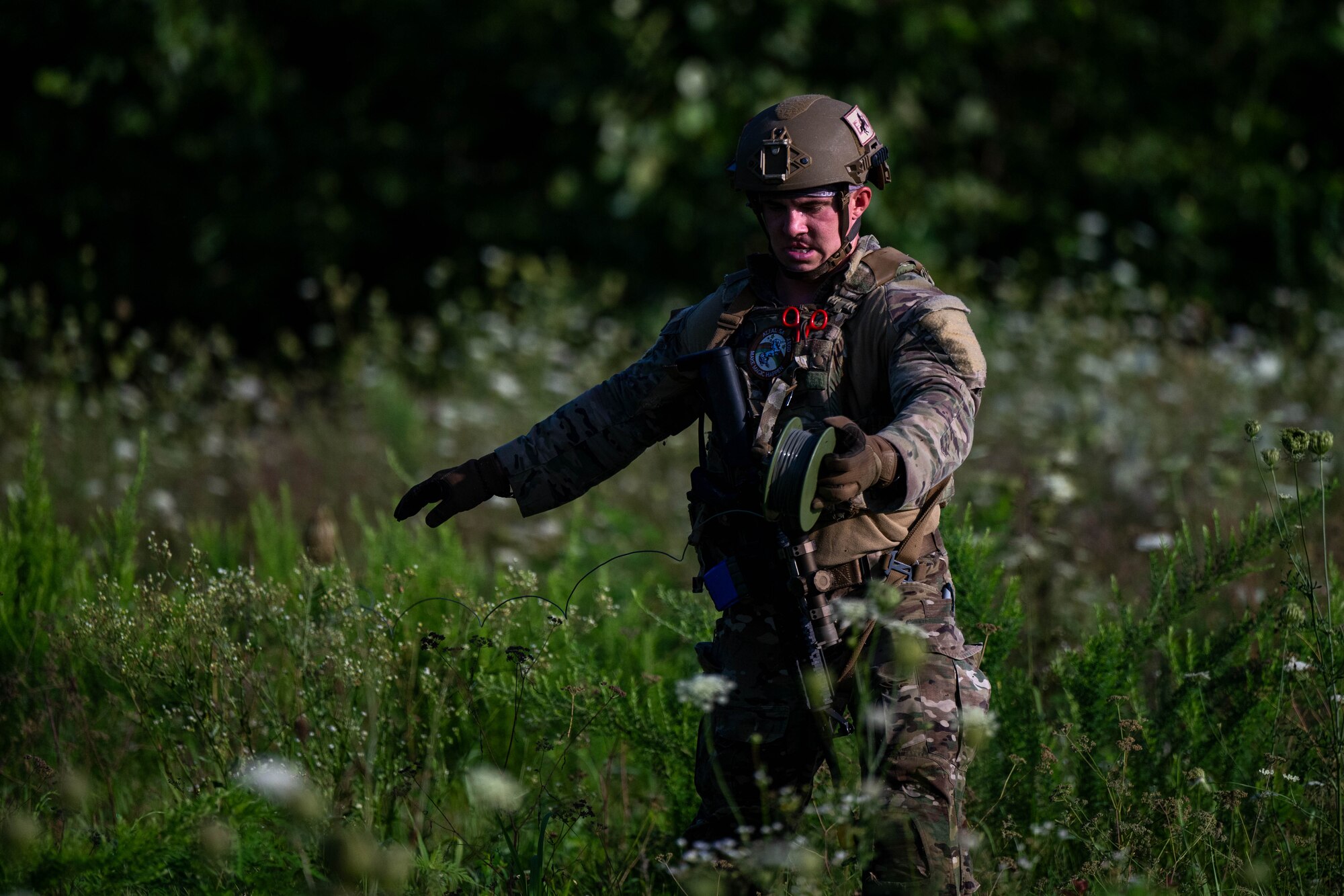 A man unrolls fire in a field