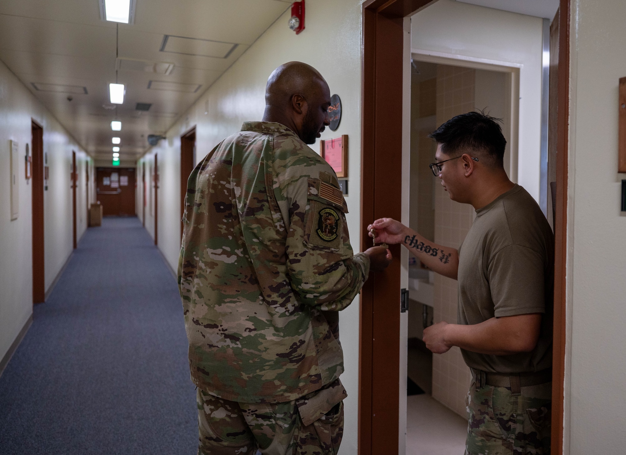 Two service members inspects keys.