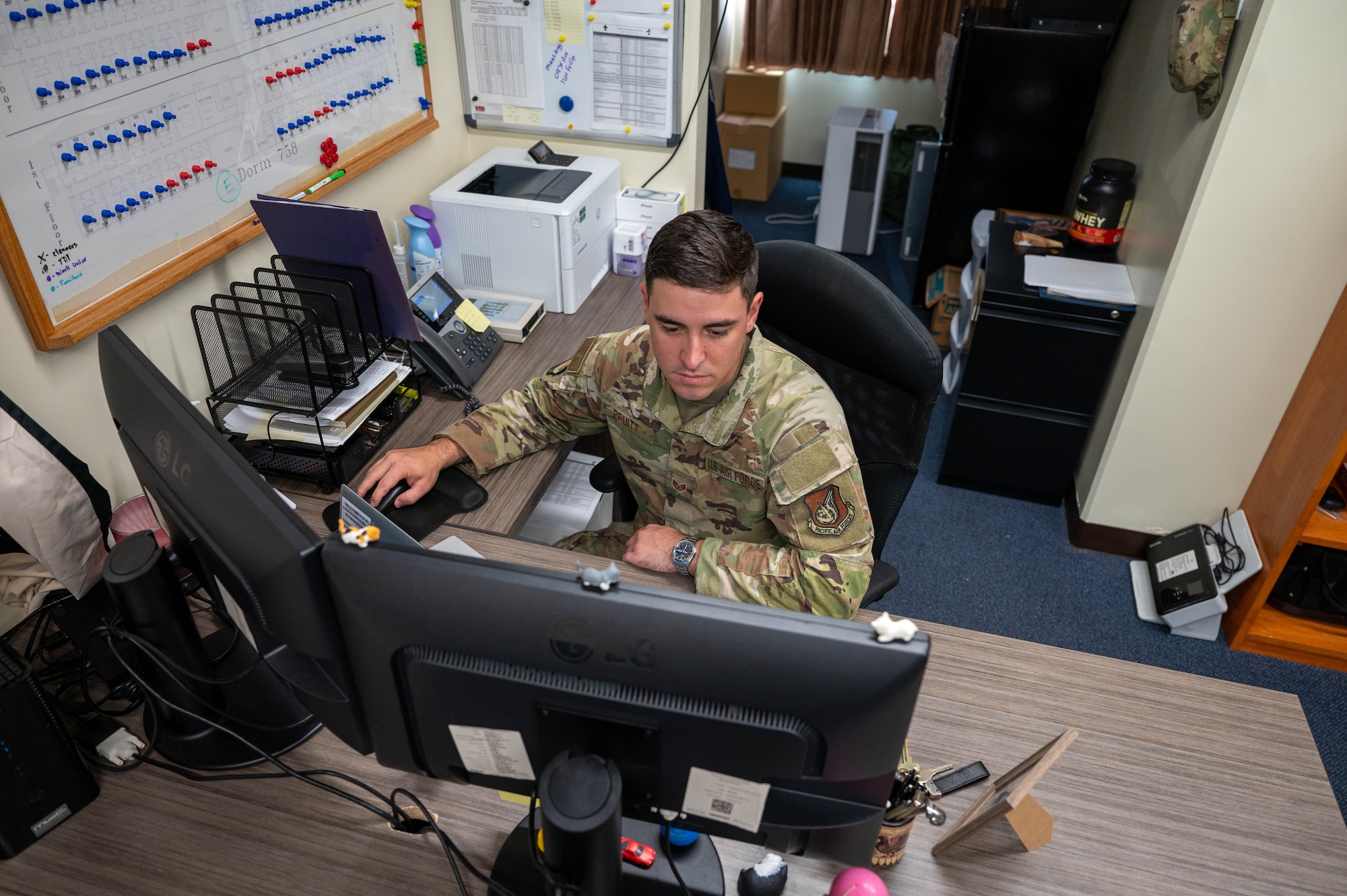 Service member works on computer.