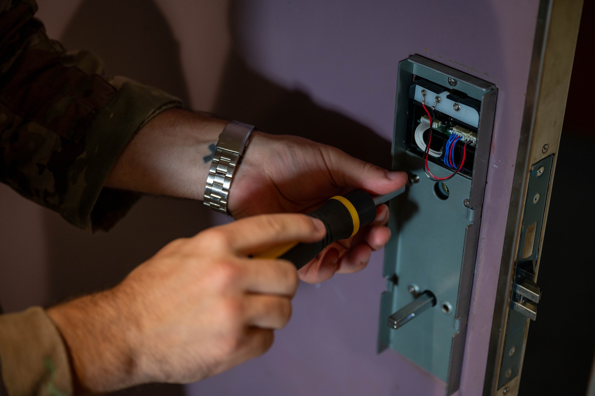 Service member replaces door handle.