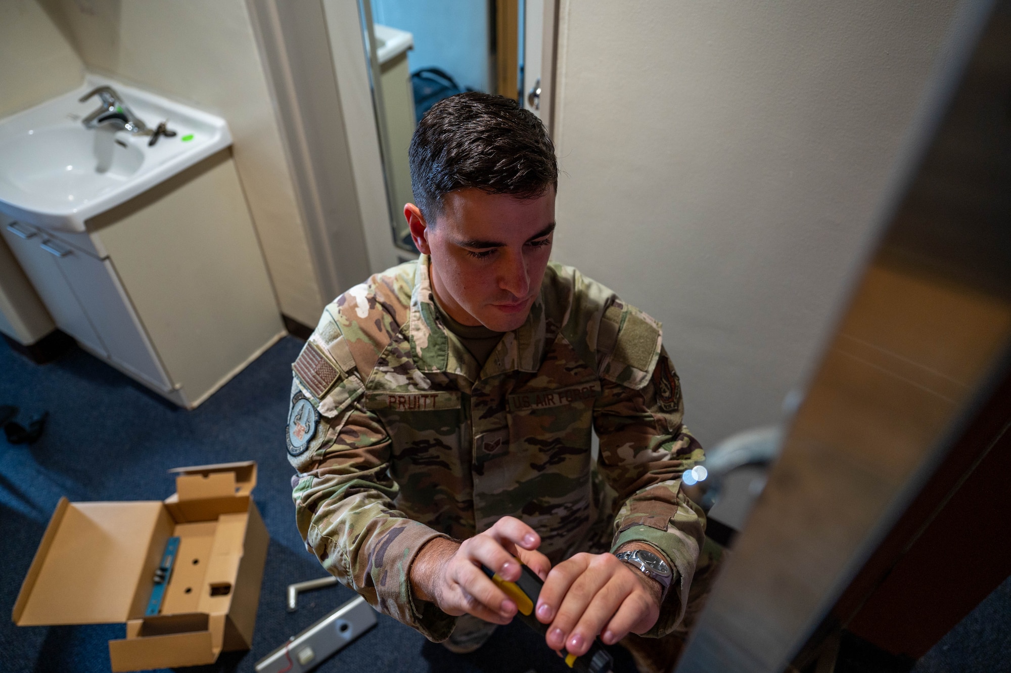 Service member replaces door handle.