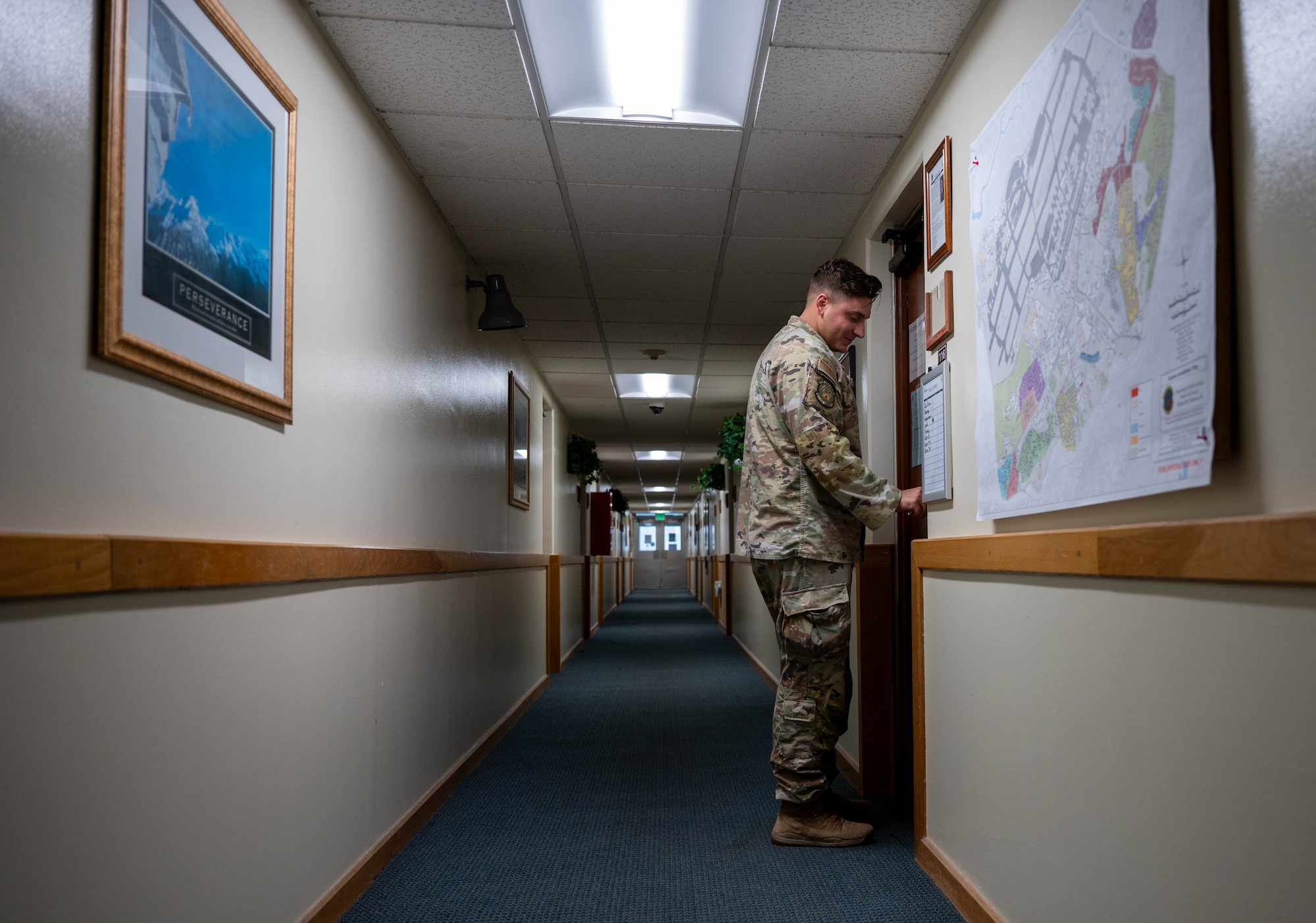 Service member unlocks office door.