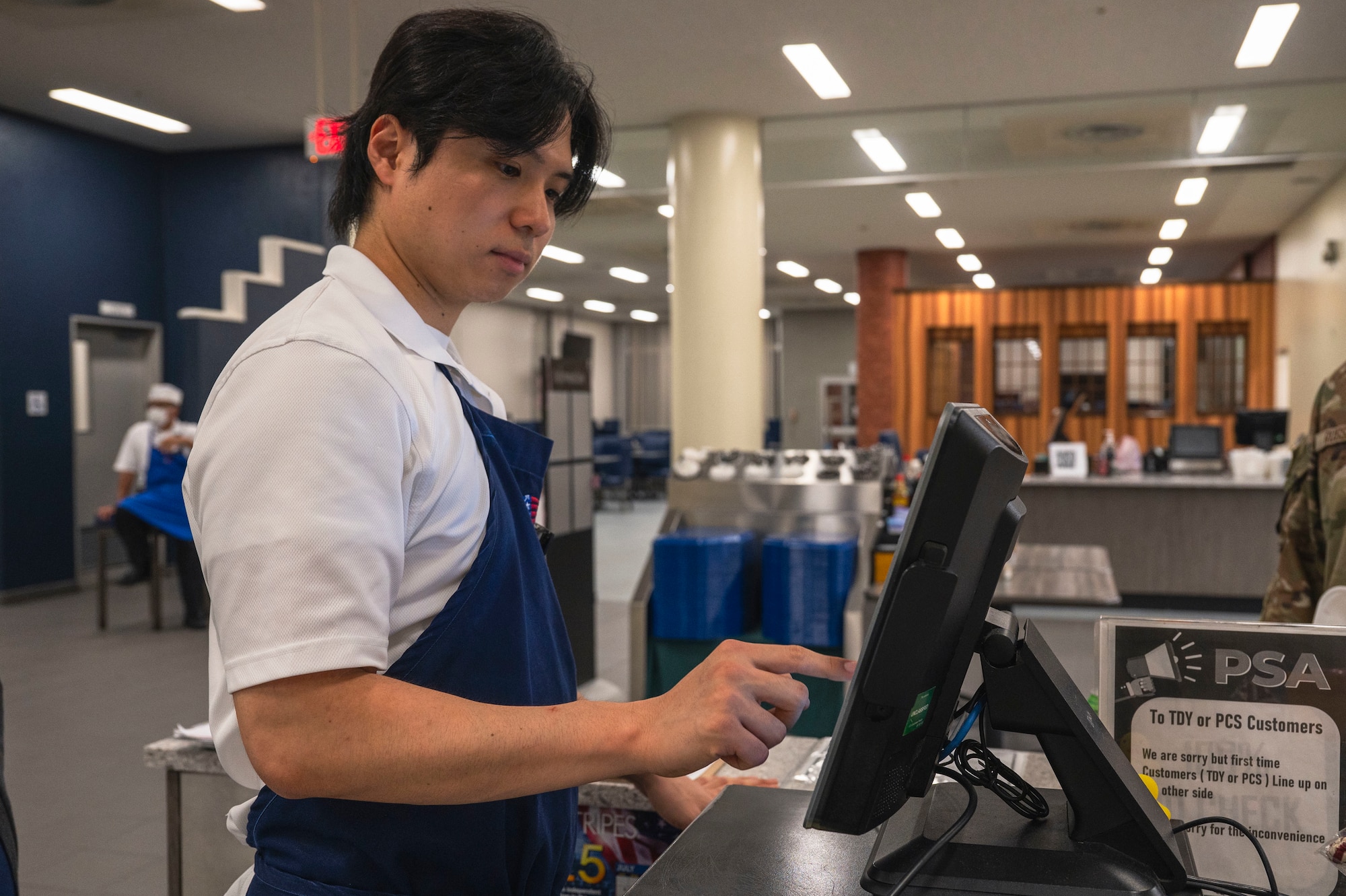 Kazu Aki, 18th Force Support Squadron food services cashier, inputs items into a register during the midnight service at the Marshall Dining Facility on Kadena Air Base, Japan, July 24, 2025.