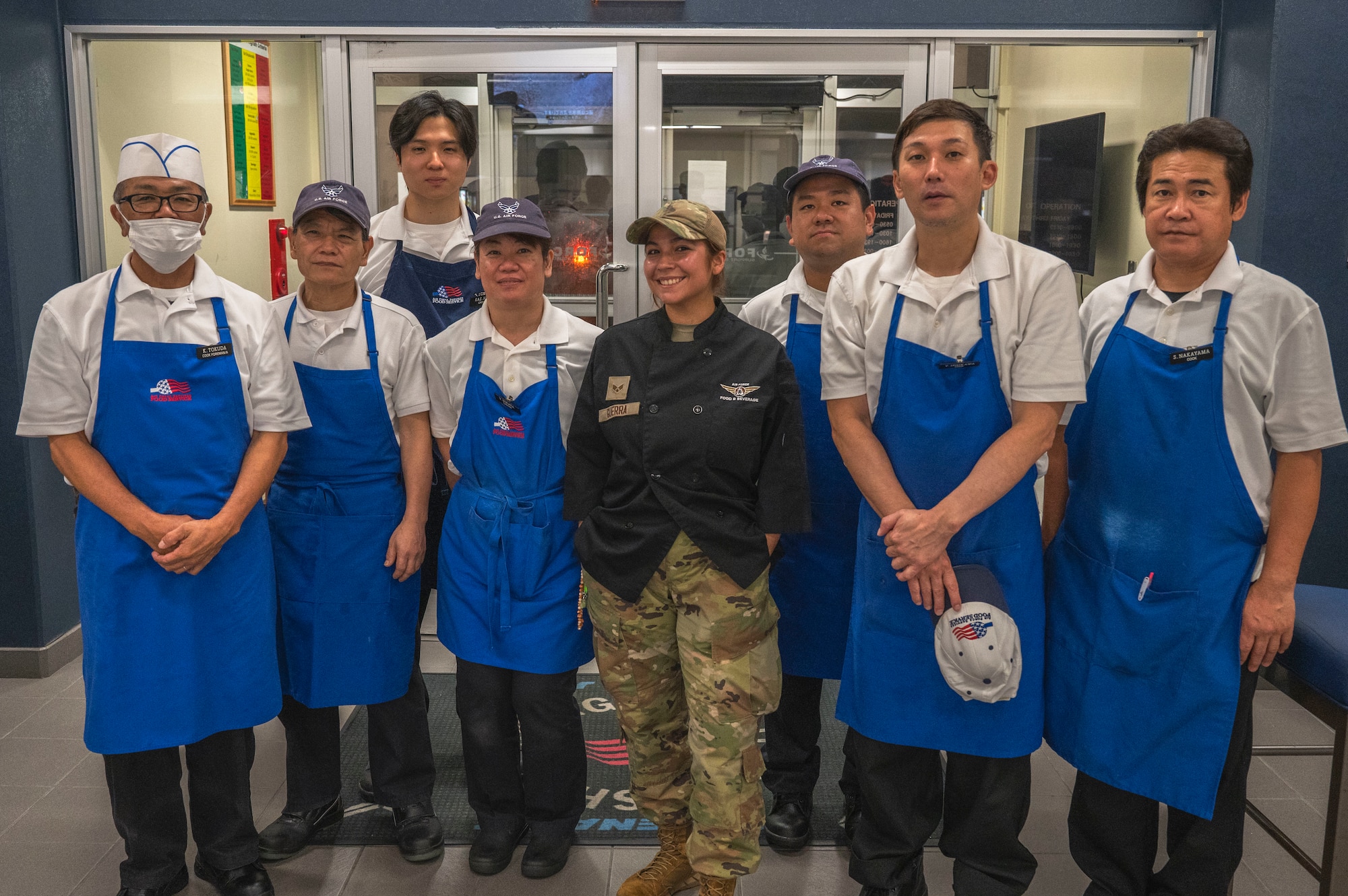 Members of the 18th Force Support Squadron food services flight pose for a photo during the midnight service at the Marshall Dining Facility on Kadena Air Base, Japan, July 24, 2025.