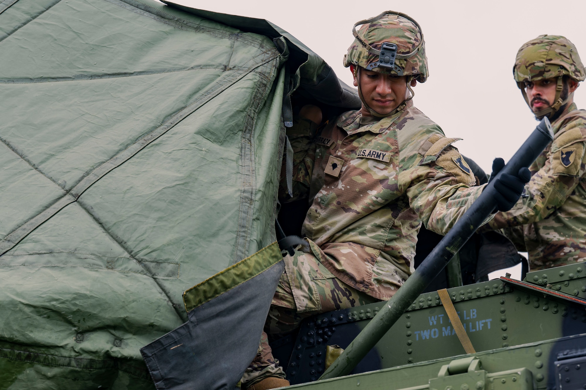 U.S. Army Spc. Diangel Barraza, 1-1 Air Defense Artillery network communications system technician, and Spc. John Cartagena, 1-1 ADA engagement controller, assemble a shroud atop an AN/MPQ-65 radar on Kadena Air Base, Japan, July 24, 2025.