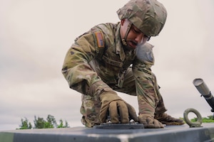 U.S. Army Pfc. Da’Mario Deal-Maddox, 1-1 Air Defense Artillery vehicle driver, tightens a fuel cap on top of an M1097A2 electric power plant on Kadena Air Base, Japan, July 24, 2025.