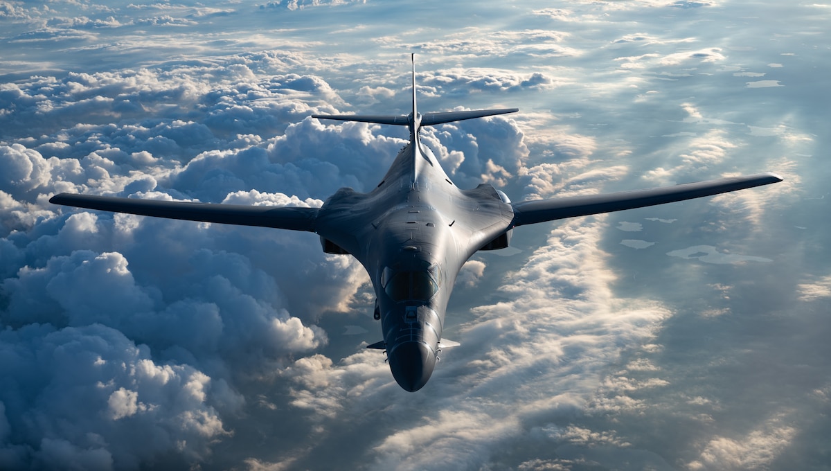 A B-1B Lancer assigned to the 34th Expeditionary Bomb Squadron, Ellsworth Air Force Base, S.D., flies over the United States, July 2, 2025. Known for its long-range, high-speed capabilities, the B-1B is a supersonic heavy bomber capable of carrying up to 75,000 pounds of guided and unguided munitions and plays a critical role in global strike operations, providing flexible payload options and precision engagement in support of U.S. and allied missions. (U.S. Air National Guard photo by Airman Spencer Strubbe)