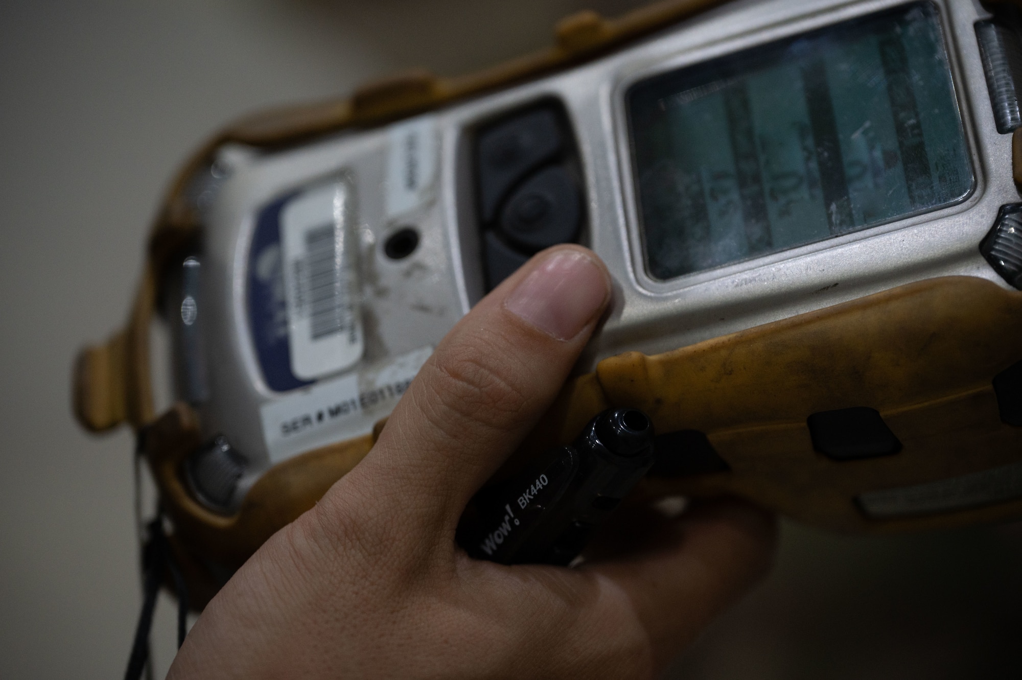 U.S. Air Force Staff Sgt. Megan Fogg, 379th Expeditionary Aircraft Maintenance Squadron fuels systems technician, checks the readings on a photoionization detector during a confined-space extraction exercise within the U.S. Central Command area of responsibility, July 21, 2025. The exercise simulated an Airman fainting in a confined space due to fuel vapors. (U.S. Air Force photo by Senior Airman Dieondiere Jefferies)