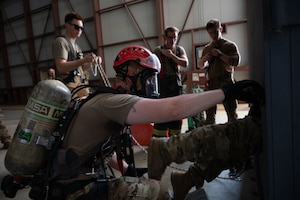 Firefighters assigned to the 379th Expeditionary Civil Engineer Squadron assist during a confined space extraction exercise within the U.S. Central Command area of responsibility, July 21, 2025. The 379th ECES is responsible for ensuring the safety of others on base and responding to emergencies. (U.S. Air Force photo by Senior Airman Dieondiere Jefferies)