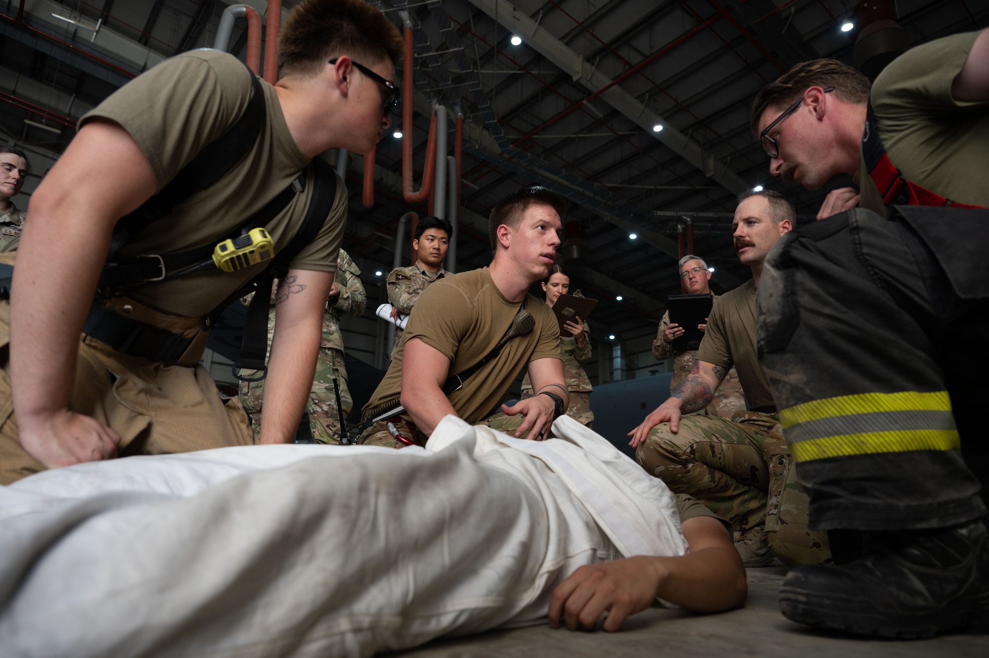 Firefighters assigned to the 379th Expeditionary Civil Engineer Squadron participate in a confined-spaces emergency exercise within the U.S. Central Command area of responsibility, July 21, 2025. The exercise gave firefighters the opportunity to respond to a confined-space emergency and rescue a simulated fainting patient. (U.S. Air Force photo by Senior Airman Dieondiere Jefferies)