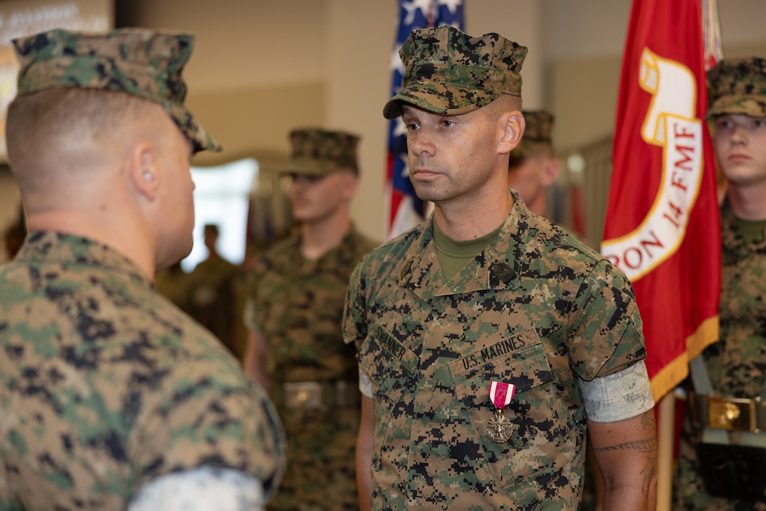 U.S. Marine Corps Lt. Col. Nicholas Verta, left, from Pennsylvania, commanding officer of Marine Aviation Logistics Squadron 14, Marine Aircraft Group 14, 2nd Marine Aircraft Wing, awards the Meritorious Service Medal to Sgt. Maj. Donald Swanner, from Maryland, former command senior enlisted leader, MALS-14, during a relief and appointment ceremony at Marine Corps Air Station Cherry Point, North Carolina, July 23, 2025. The ceremony represented a transfer of responsibility, authority, and accountability from Swanner to Sgt. Maj. Christianna Wolford. (U.S. Marine Corps photo by Lance Cpl. Orlanys Diaz Figueroa)
