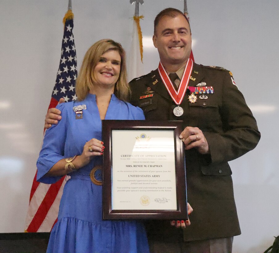 U.S. Army Corps of Engineers, Mobile District commander Col. Jeremy Chapman poses with his wife Renee Chapman after she receives her retirement certificate