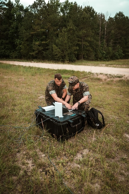 Staff Sgt. Dunn, a representative for Tactical Communications and Electromagnetic Warfare Systems (TCE), and Master Sgt. Daniel Brown, II Marine Expeditionary Force Communications Strategy and Operations, conduct setup and alignment of a Star Shield antenna during an Expeditionary Field Training Exercise at Camp Lejeune, N.C.
