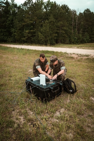 Staff Sgt. Dunn, a representative for Tactical Communications and Electromagnetic Warfare Systems (TCE), and Master Sgt. Daniel Brown, II Marine Expeditionary Force Communications Strategy and Operations, conduct setup and alignment of a Star Shield antenna during an Expeditionary Field Training Exercise at Camp Lejeune, N.C.
