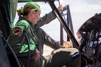 U.S. Air Force Academy Cadet Kate Fleming enters a UH-1N Huey helicopter during a tour of the 1st Helicopter Squadron at Joint Base Andrews, Md., July 17, 2025. Cadets visited JBA and Joint Base Anacostia-Bolling, Washington, D.C., as part of USAFA’s Summer Operations program to learn more about officer life and the operational Air Force. (U.S. Air Force photo by Hayden Hallman)