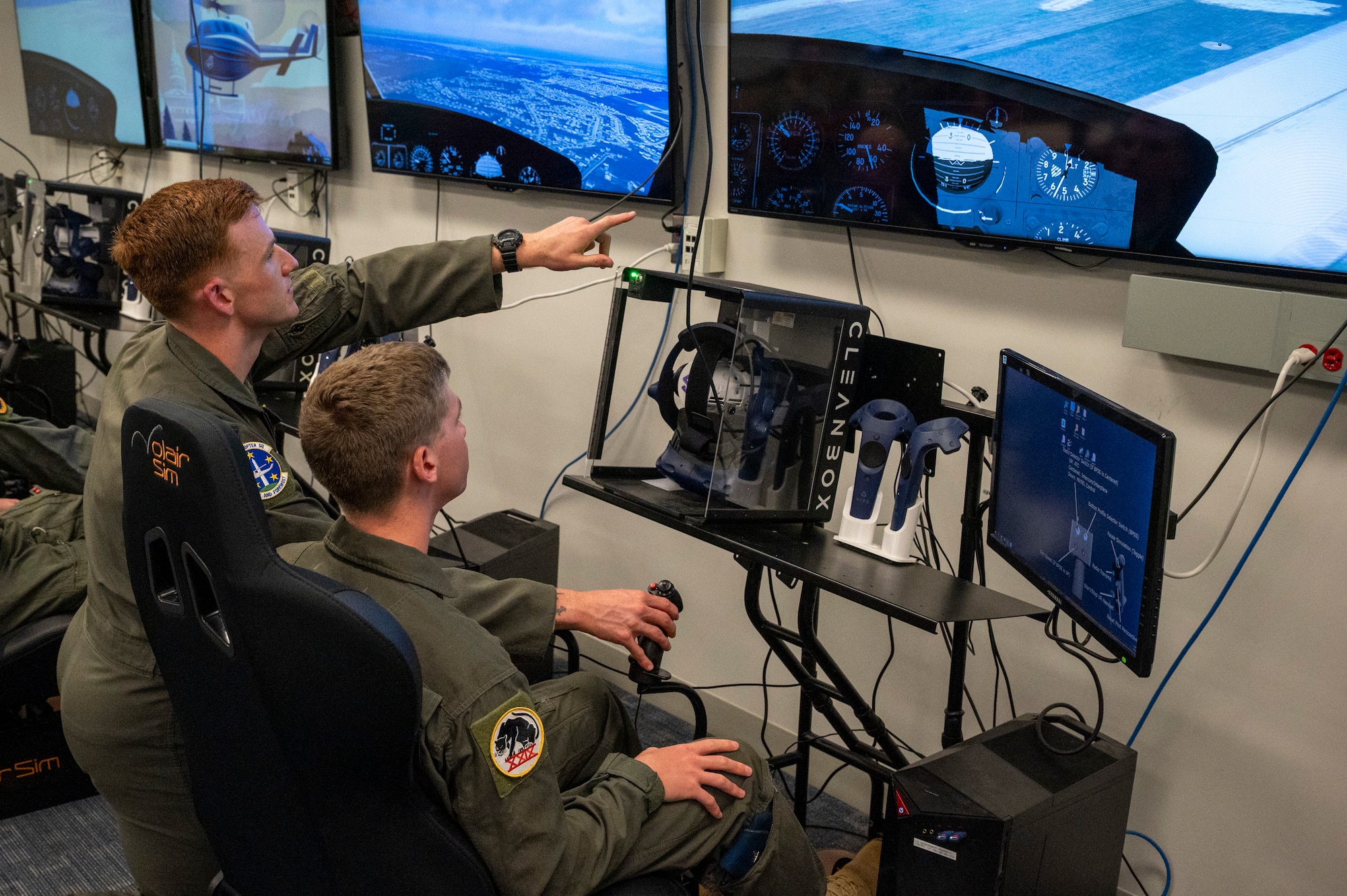 U.S. Air Force Capt. Vance Holub, a pilot with the 1st Helicopter Squadron, instructs U.S. Air Force Academy Cadet Kenneth Reel in a virtual reality lab at Joint Base Andrews, Md., July 17, 2025. Cadets visited JBA and Joint Base Anacostia-Bolling, Washington, D.C., as part of USAFA’s Summer Operations program to learn more about officer life and the operational Air Force. (U.S. Air Force photo by Hayden Hallman)
