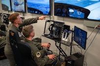 U.S. Air Force Capt. Vance Holub, a pilot with the 1st Helicopter Squadron, instructs U.S. Air Force Academy Cadet Kenneth Reel in a virtual reality lab at Joint Base Andrews, Md., July 17, 2025. Cadets visited JBA and Joint Base Anacostia-Bolling, Washington, D.C., as part of USAFA’s Summer Operations program to learn more about officer life and the operational Air Force. (U.S. Air Force photo by Hayden Hallman)